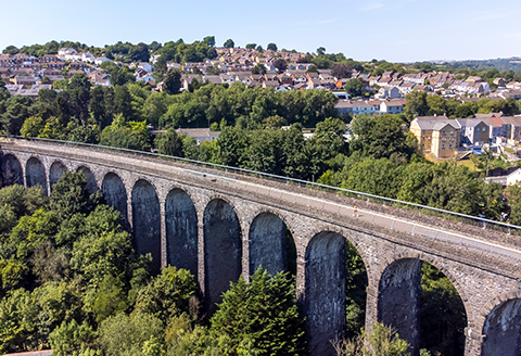 The Hengoed viaduct seen from the air. Rows of houses and the valley beyond can be seen in the distance.)