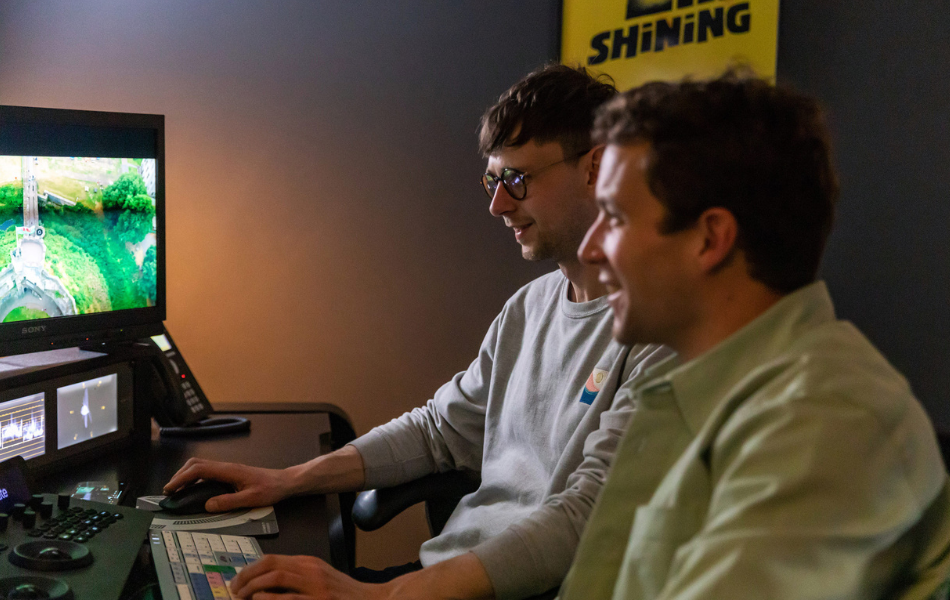 Two guys looking at a screen in an office