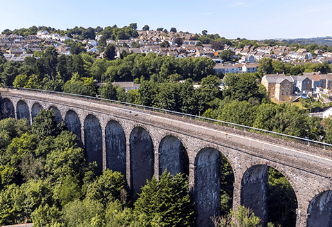 The Hengoed viaduct seen from the air. Rows of houses and the valley beyond can be seen in the distance.