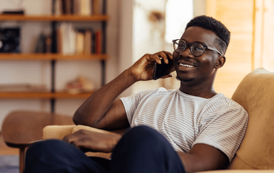 Person smiling while talking on the phone
